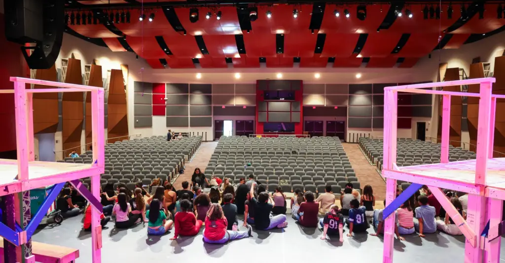 Students take a break during a dress rehearsal of the...