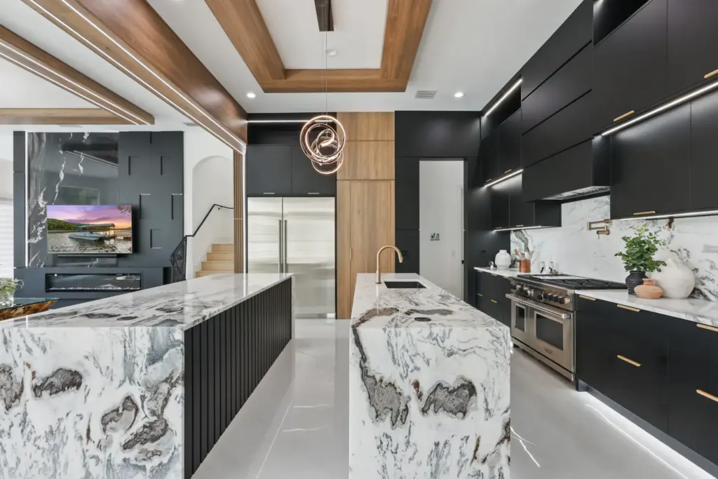 The gourmet kitchen features double islands and is equipped with...