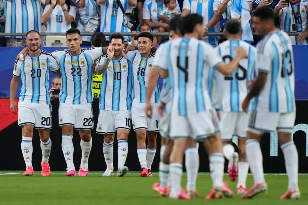 Argentina’s Lionel Messi, third left, celebrates with teammates after scoring...