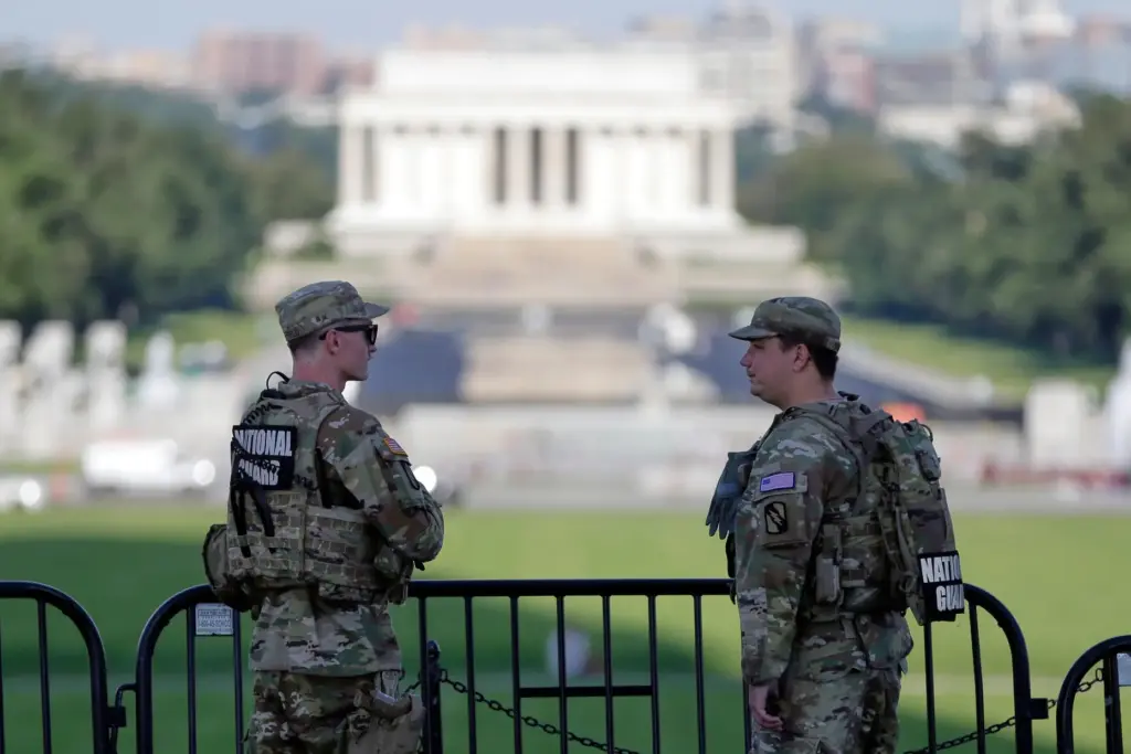 National Guard soldiers patrol at the base of the Washington...