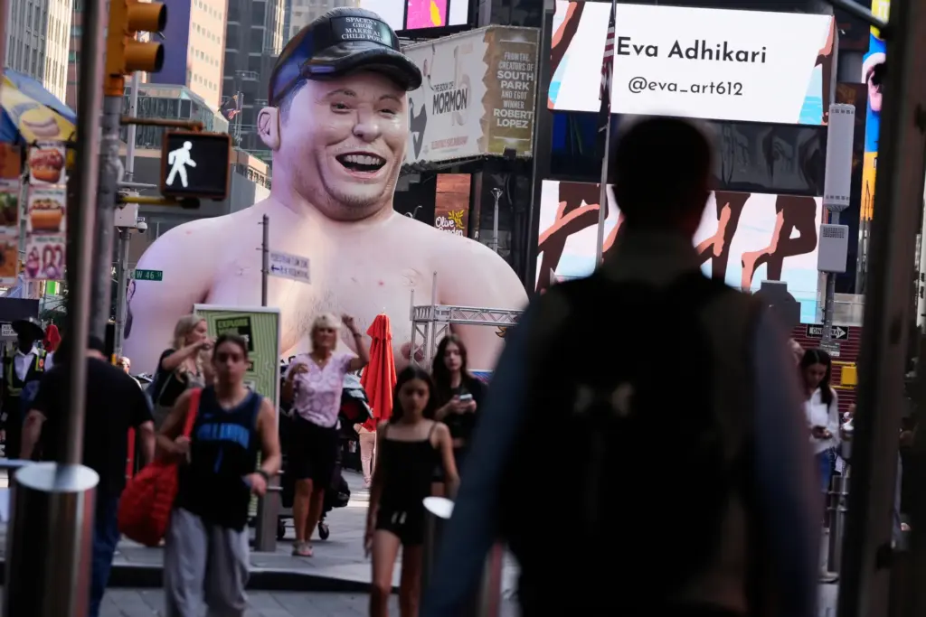 A large inflatable figure depicting Elon Musk stands in Times Square.