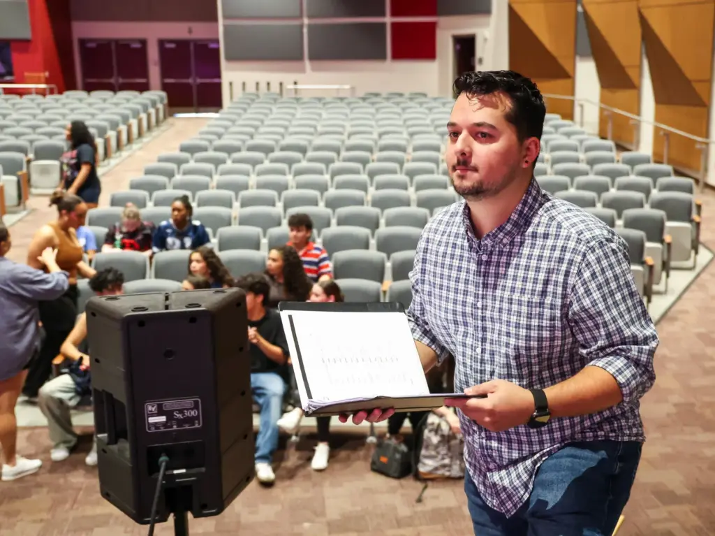University High School Theater Director Alex Mendez takes the stage...
