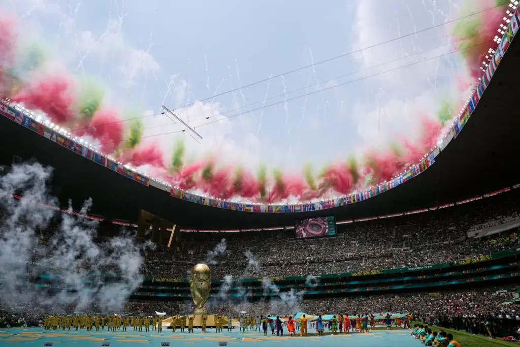 Fireworks go off above the stadium during the opening ceremony...