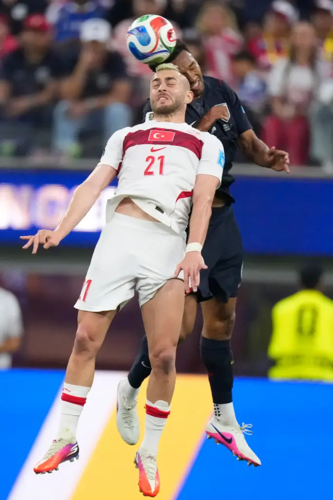 Turkey’s Baris Alper Yilmaz heads the ball during a World...