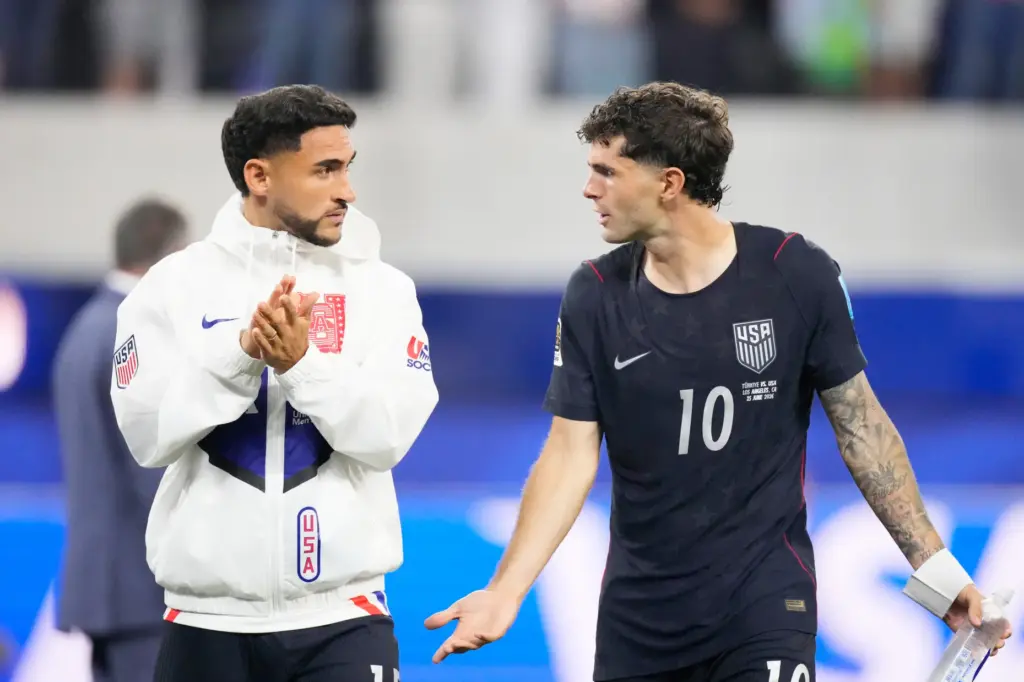 United States’ Christian Pulisic, right, walks off the field after...
