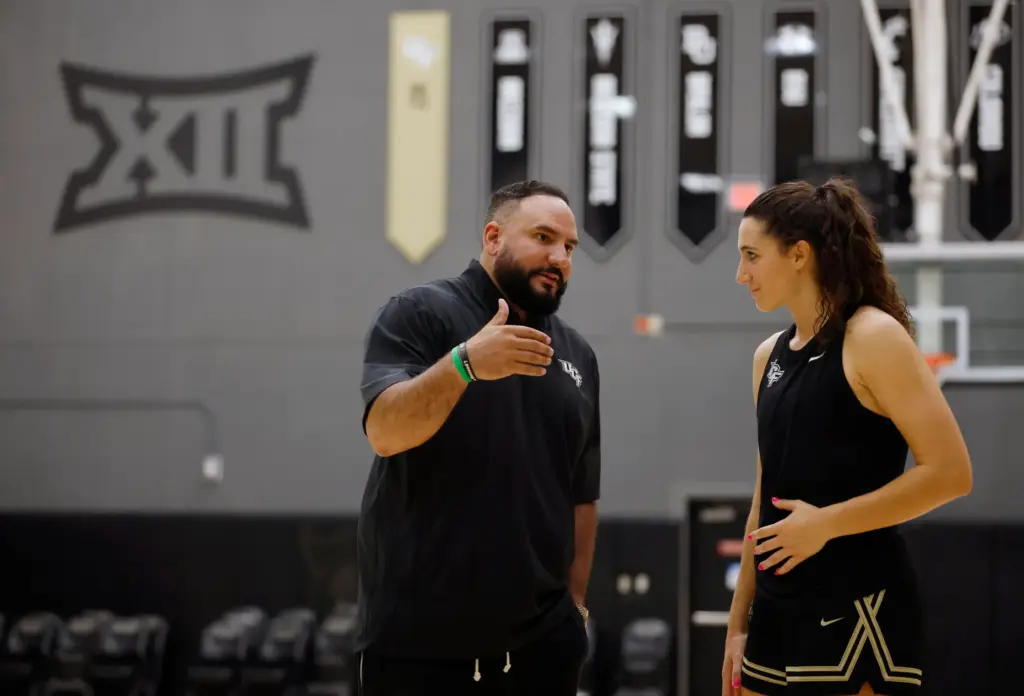 UCF women's basketball coach Gabe Lazo talks with guard Vittoria Blasigh (10) after team practice, on Wednesday, June 24, 2026. (Ricardo Ramirez Buxeda/ Orlando Sentinel)