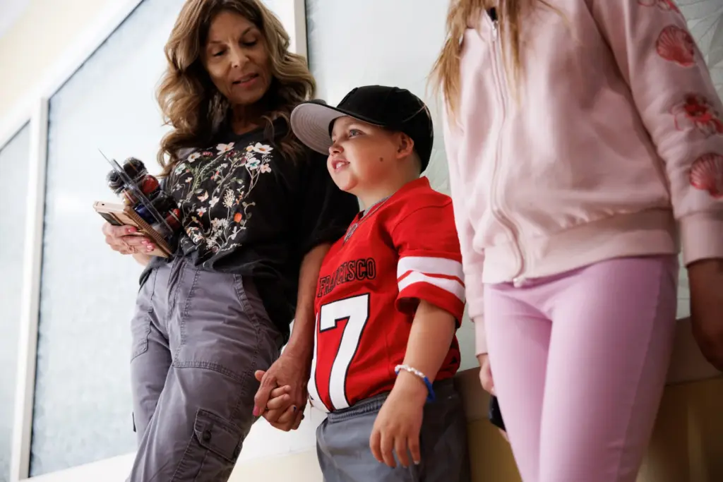 Patient Stephen De La Torre, 7, waits with his family...