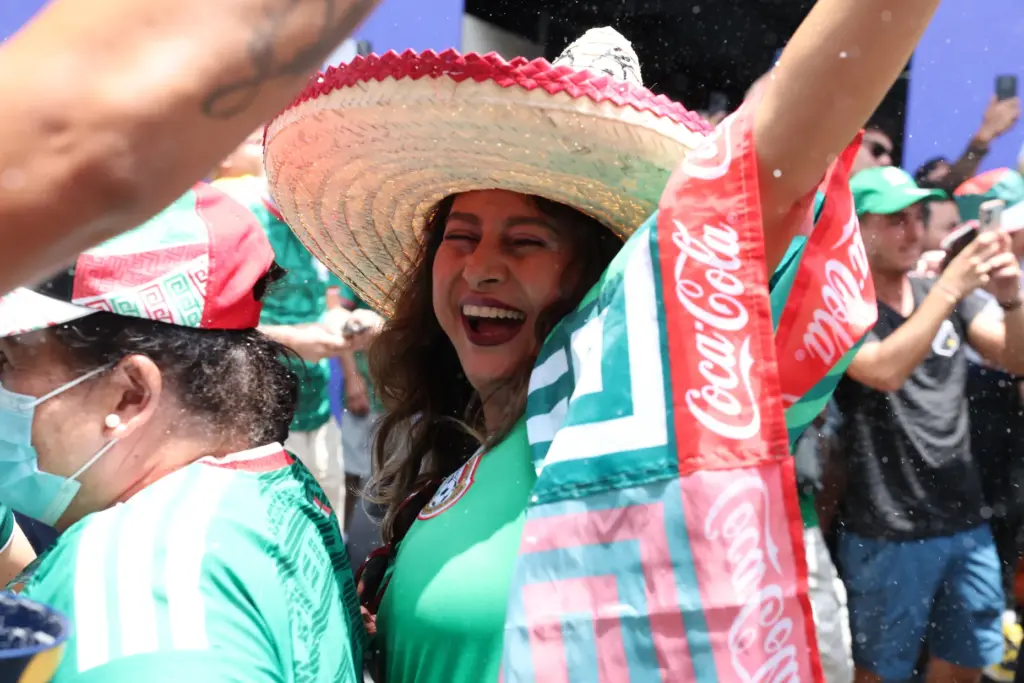 Fans celebrate Mexico’s first goal as they to watch a...
