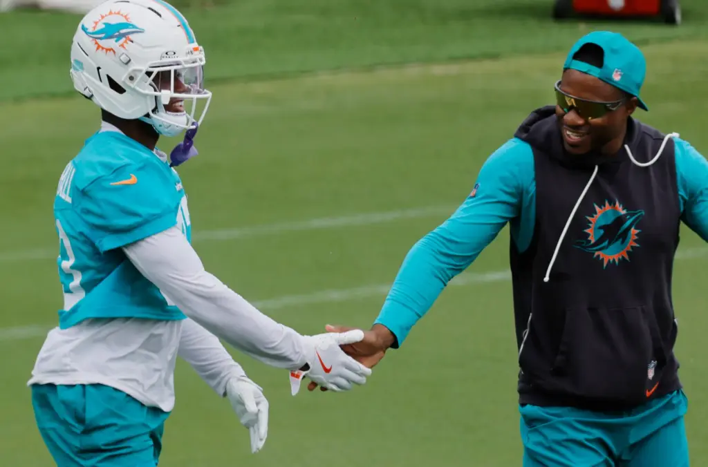 Miami Dolphins Jason Marshall Jr., left, reacts with defensive backs...
