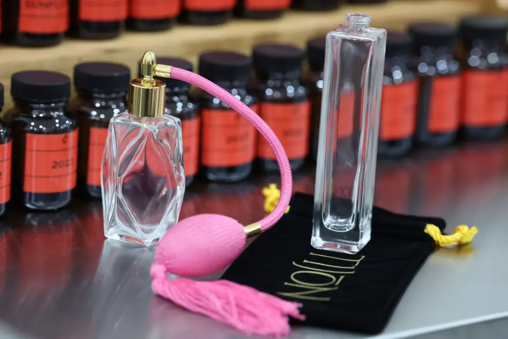 A perfume bottle and ingredients are pictured during a grand...