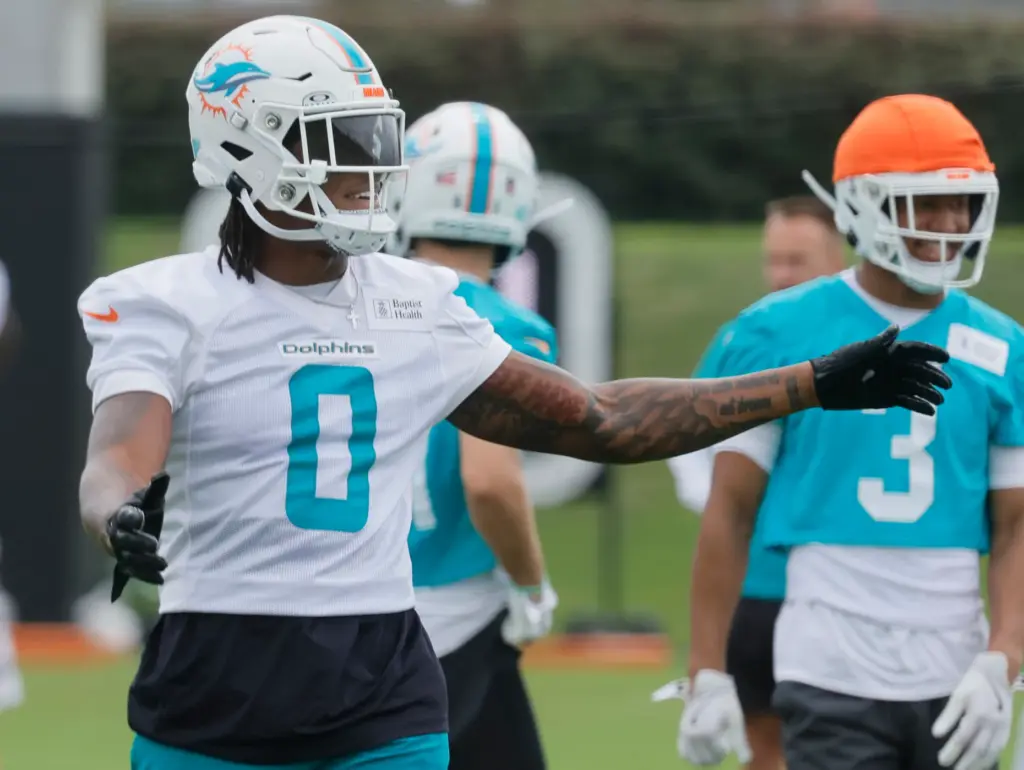 Miami Dolphins running back Ollie Gordon talks to teammates during...