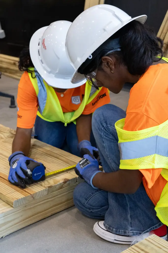 Campers begin by measuring for the planters box construction project...