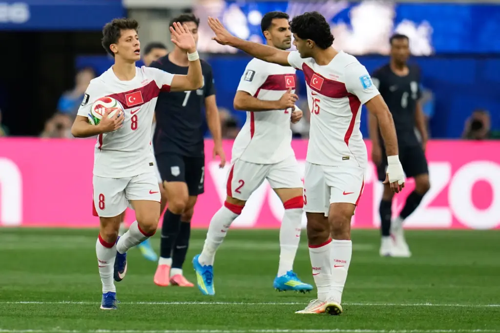 Turkey’s Arda Guler (8) is congratulated by teammate Ozan Kabak...
