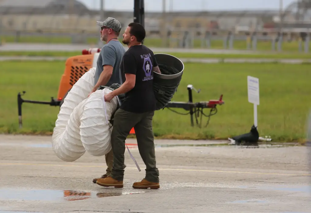 Workers cart off duct work that was keeping NASA's Nancy...