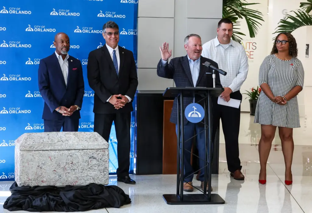RETRO REVEAL â Orlando mayor Buddy Dyer delivers remarks during...