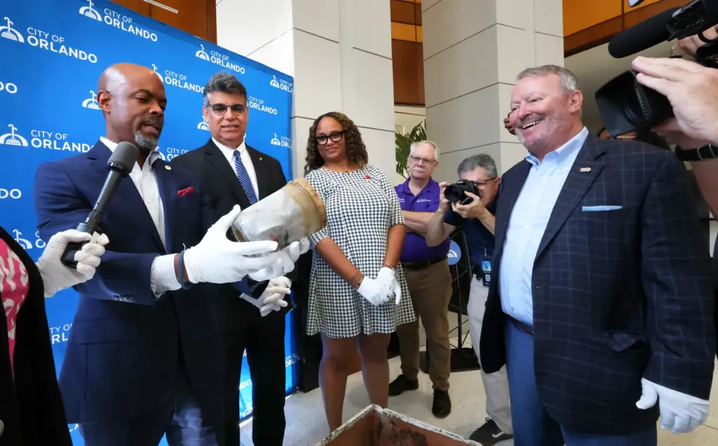 RETRO REVEAL â Orlando mayor Buddy Dyer watches as commissioner...