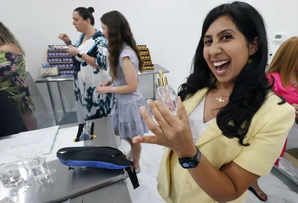 FL Rep. Anna Eskamani enjoys a perfume sample during a...