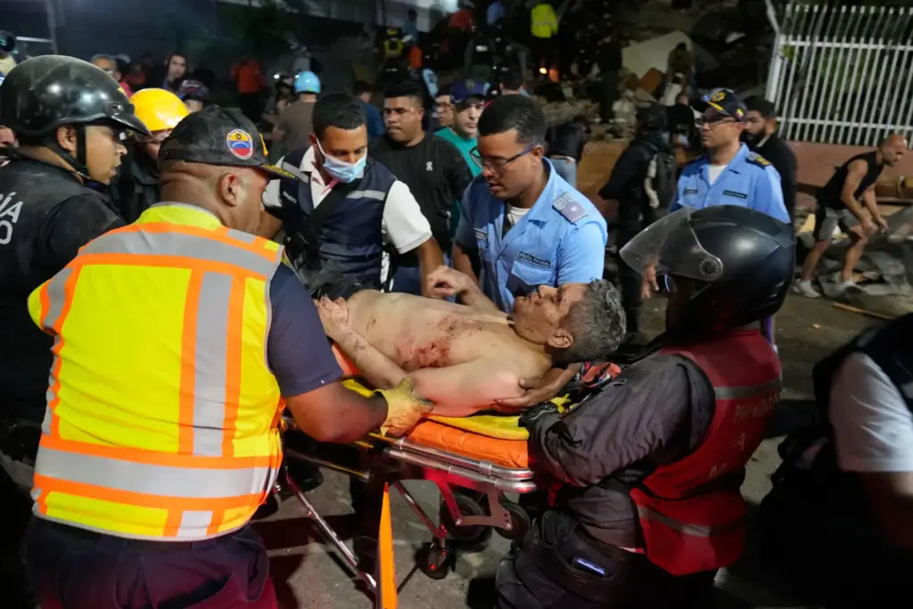 Rescue workers carry an injured man after an earthquake in Caracas, Venezuela.