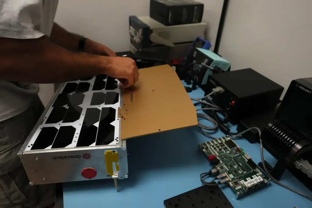 Michel Farah, an OroraTech software engineer, works on a replica...