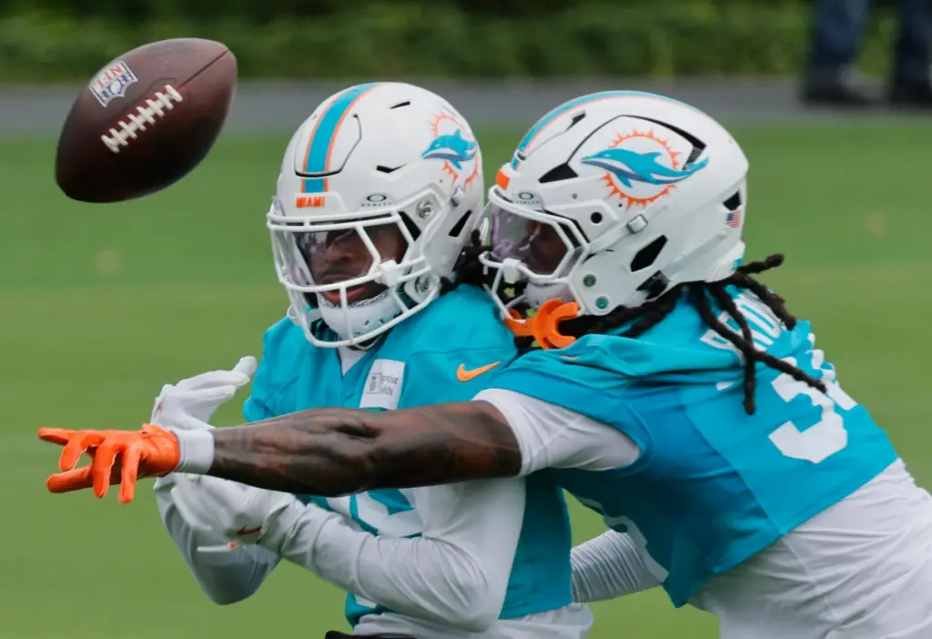 Miami Dolphins cornerback Ethan Robinson, left, and safety Omar Brown fight for a ball during mandatory minicamp at the Baptist Health Training Complex in Miami Gardens on Thursday, June 4, 2026. (Joe Cavaretta/South Florida Sun Sentinel)