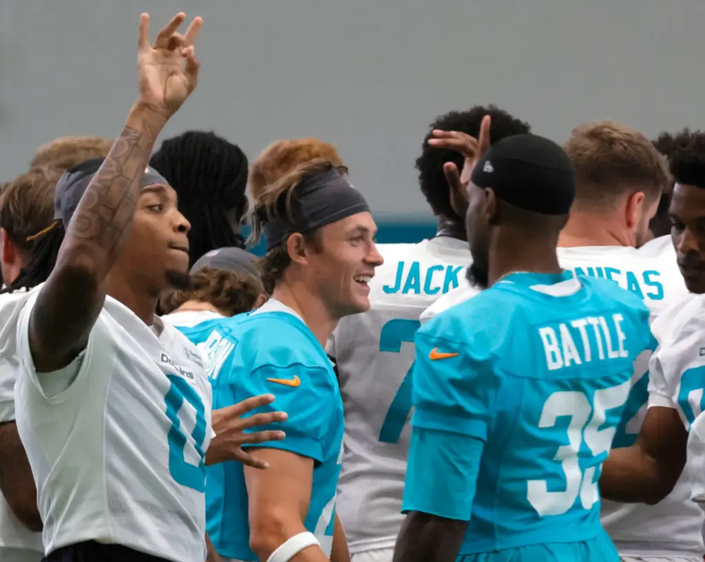Miami Dolphins running back Ollie Gordon motions to teammates after...