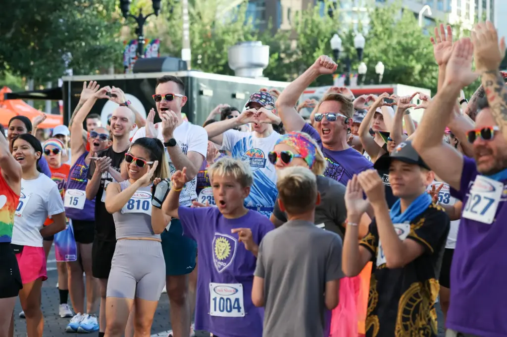 Runners get pumped up before the start of the 10th...