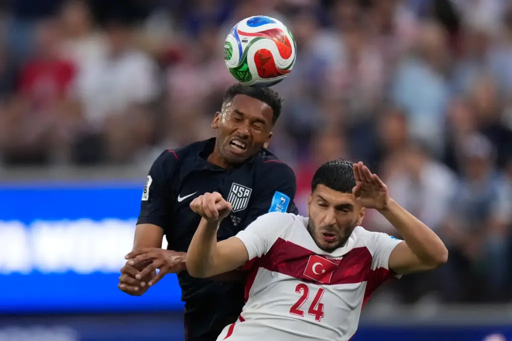 United States’ Auston Trusty, left and Turkey’s Oguz Aydin go...