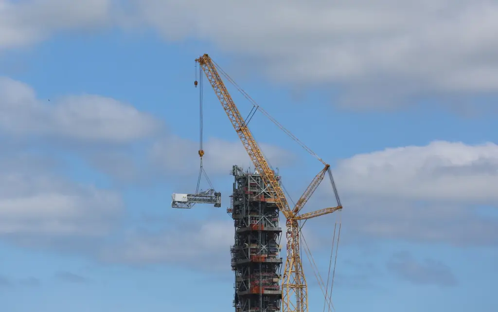 A crane removes the crew access arm from mobile launcher...