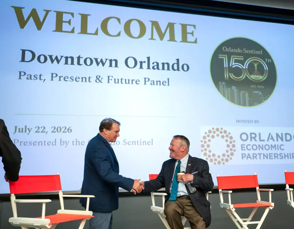 DISCUSSING DOWNTOWN â Orlando mayor Buddy Dyer, right, greets downtown...