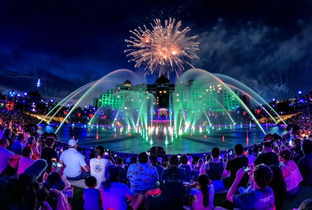 Guests watch the debut of the first nighttime finale fireworks...
