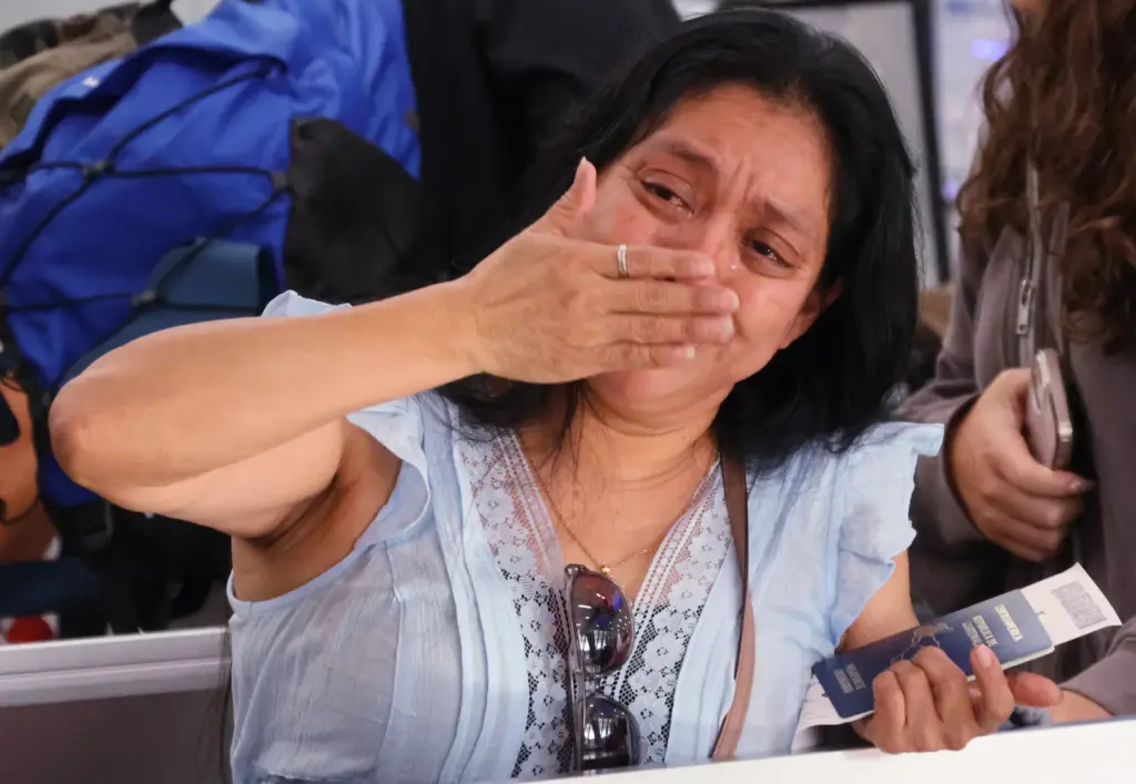 Olga Perez, longtime translator for the Guatemala Maya Center in Lake Worth Beach, says goodbye to family and friends as she prepares to board a flight to Guatemala City on Monday at Fort Lauderdale-Hollywood International Airport. A refugee from violence in her country decades ago, she self-deported after being detained by ICE. (Joe Cavaretta/South Florida Sun Sentinel)