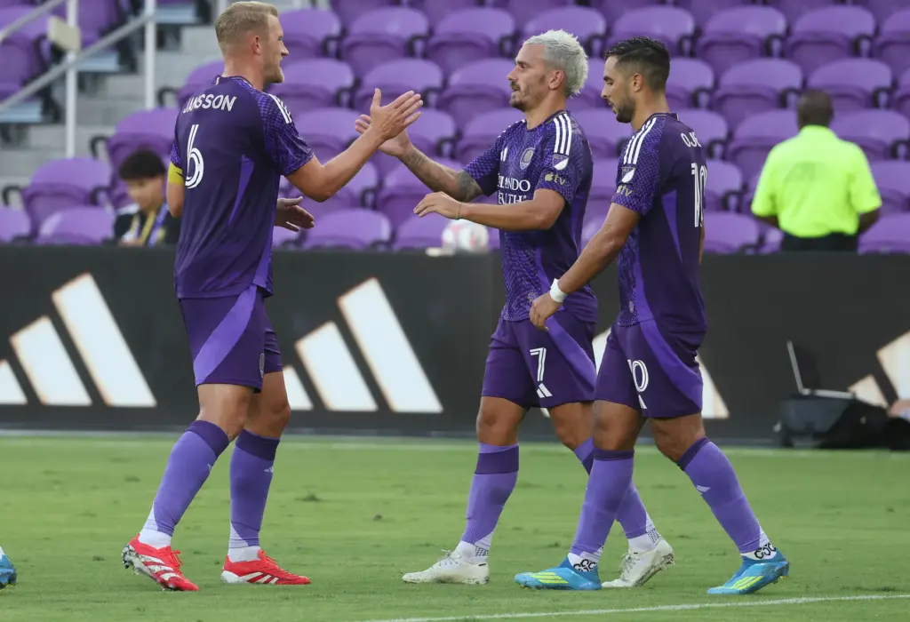 Orlando City players Robin Jansson (6), Antoine Griezmann (7) and...