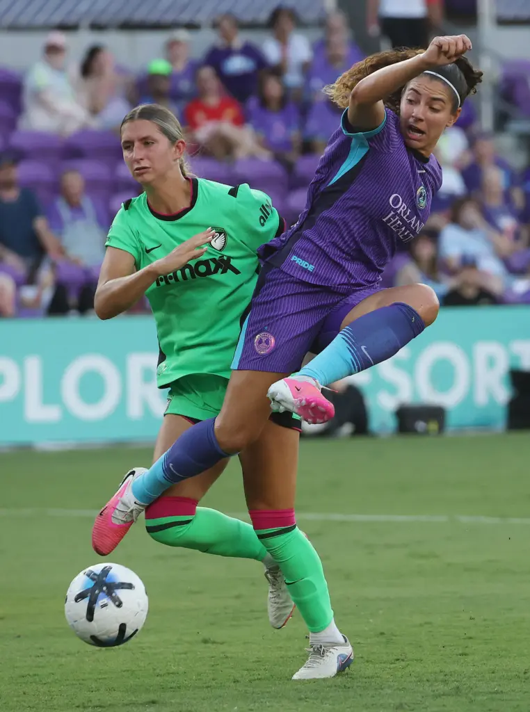 Orlando player Angelina (top) leaps over Boston player Emerson Elgin...