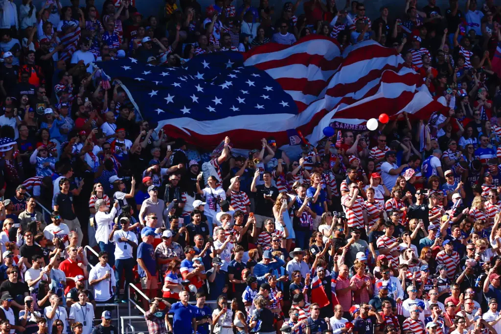 United States fans wave the United States Flag during a...