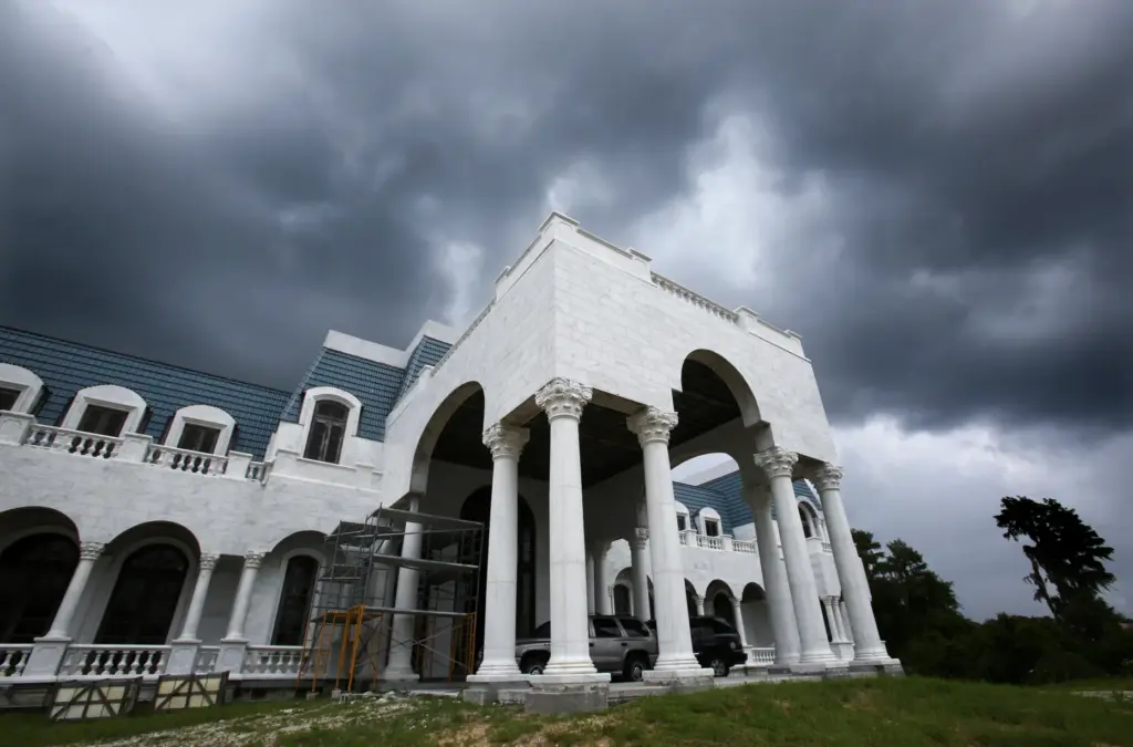 Storm clouds gather over the Versailles mansion being built by...