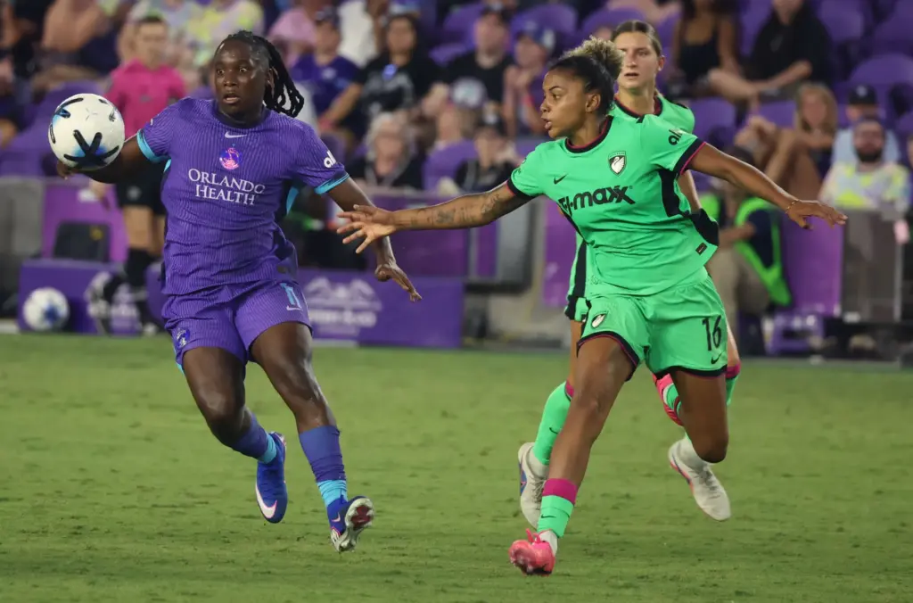 Orlando player Barbra Banda, left, chases the ball beside Boston...