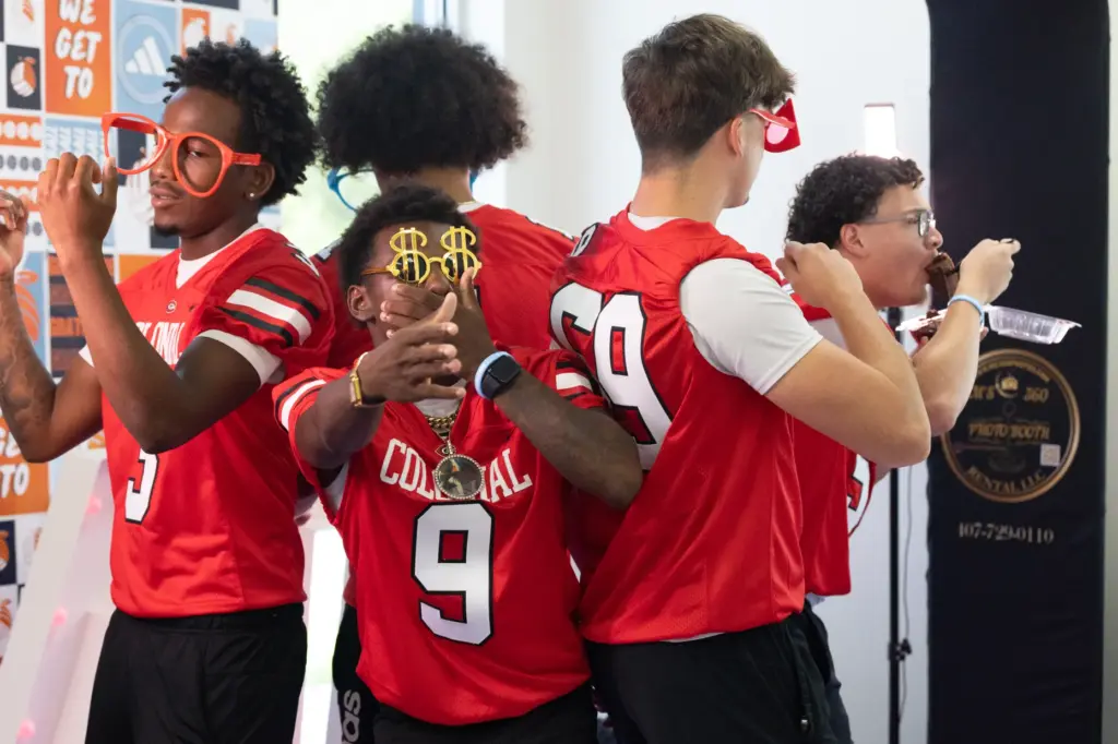Players from Colonial High School dance and one eats his...