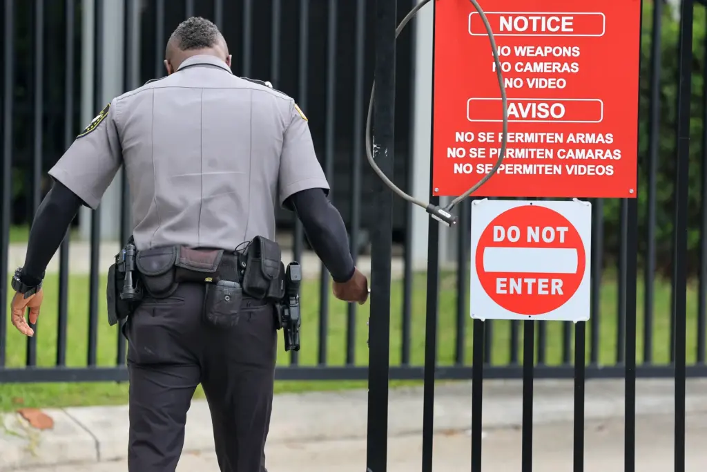 A guard closes the gate at the ICE Enforcement and...