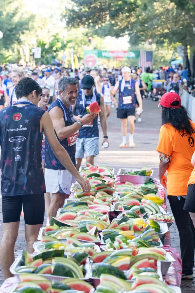 Runners grab their watermelon after finishing the Watermelon 5K at...