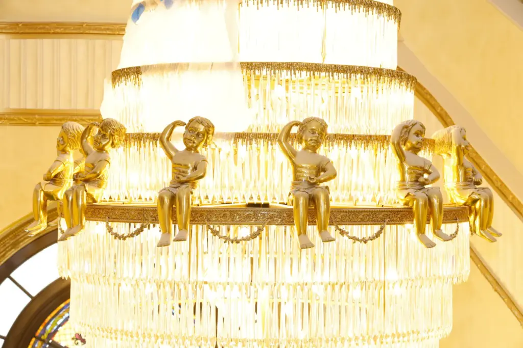 Ornate cherubs detail a crystal chandelier hanging inside the mega-mansion....