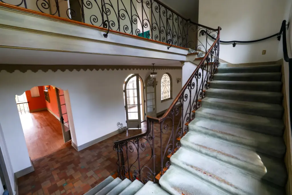 The main staircase in the entry hall in Merrywood has...