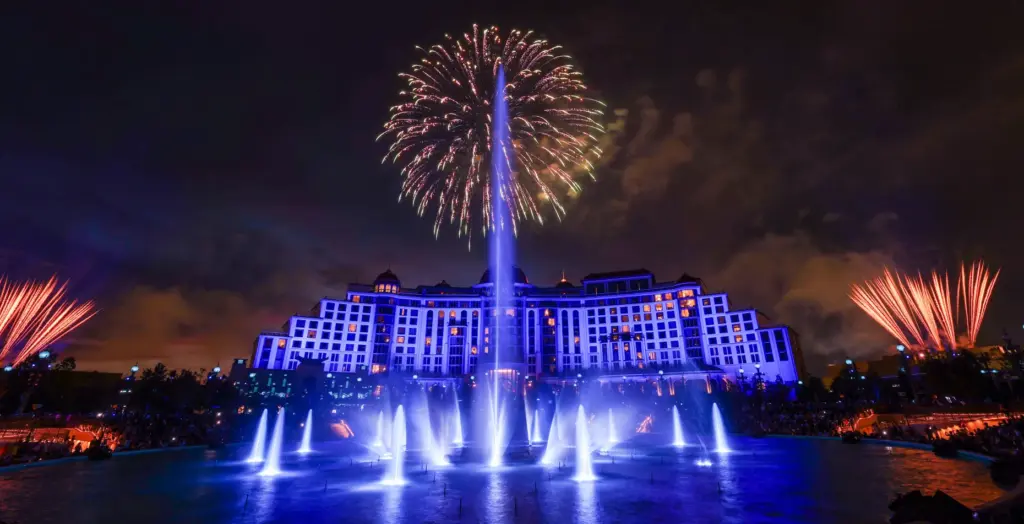 Guests watch the debut of the first nighttime finale fireworks...