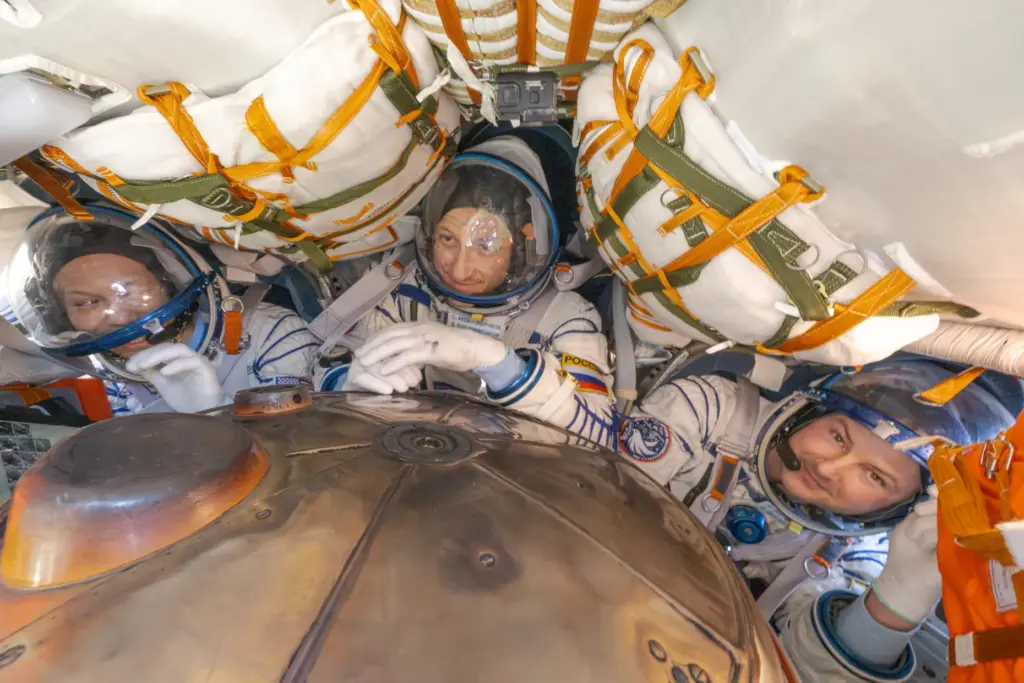 NASA astronaut Chris Williams, left, Roscosmos cosmonaut Sergey Kud-Sverchkov, center,...