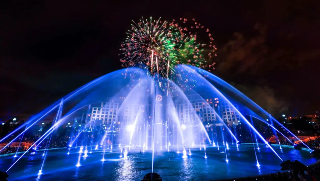 Guests watch the debut of the first nighttime finale fireworks...