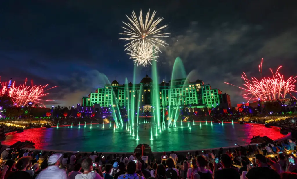 Guests watch the debut of the first nighttime finale fireworks...