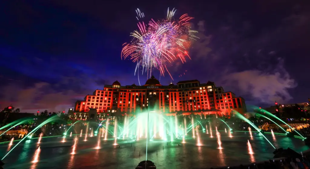 Guests watch the debut of the first nighttime finale fireworks...