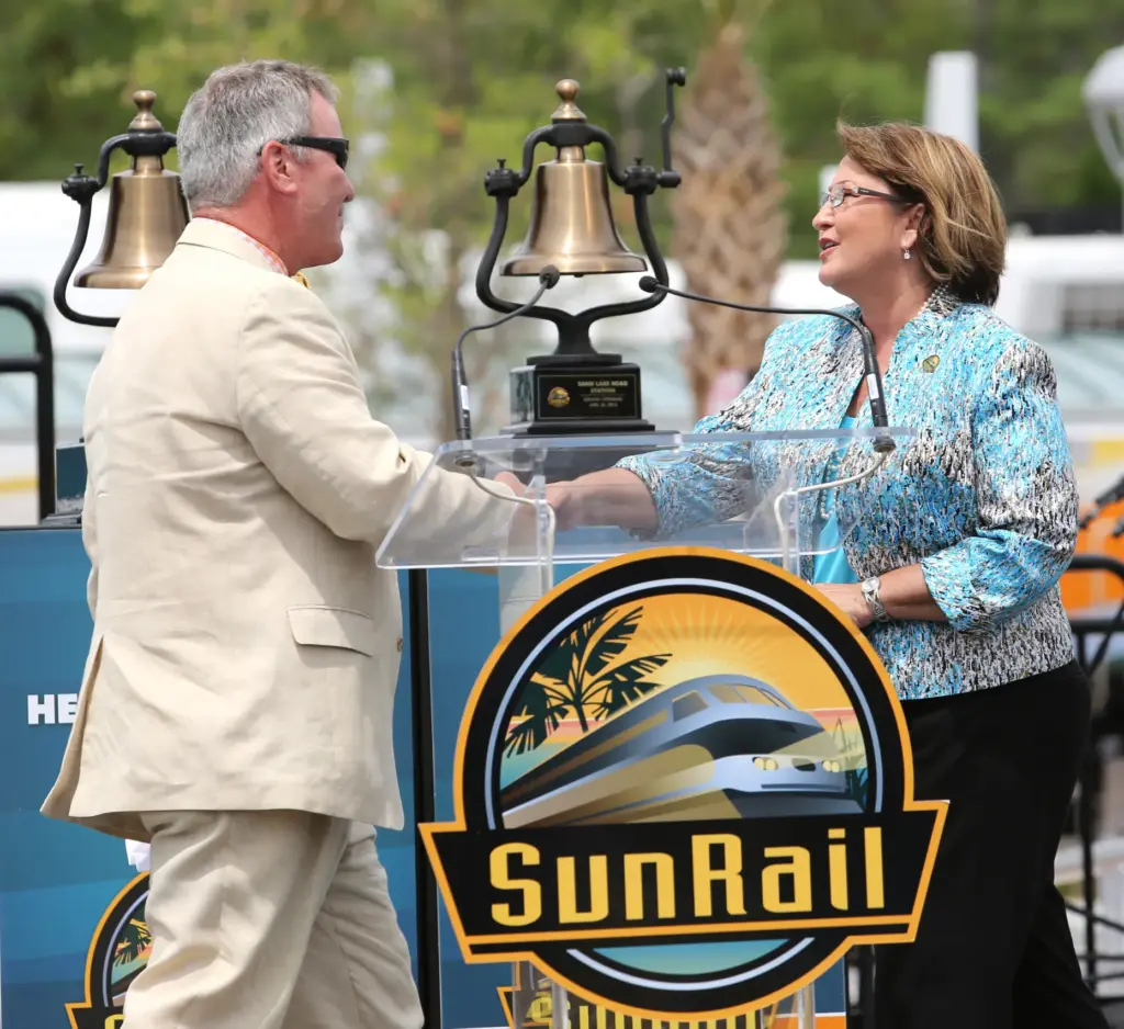 Orlando Mayor Buddy Dyer is greeted by Orange County Mayor...