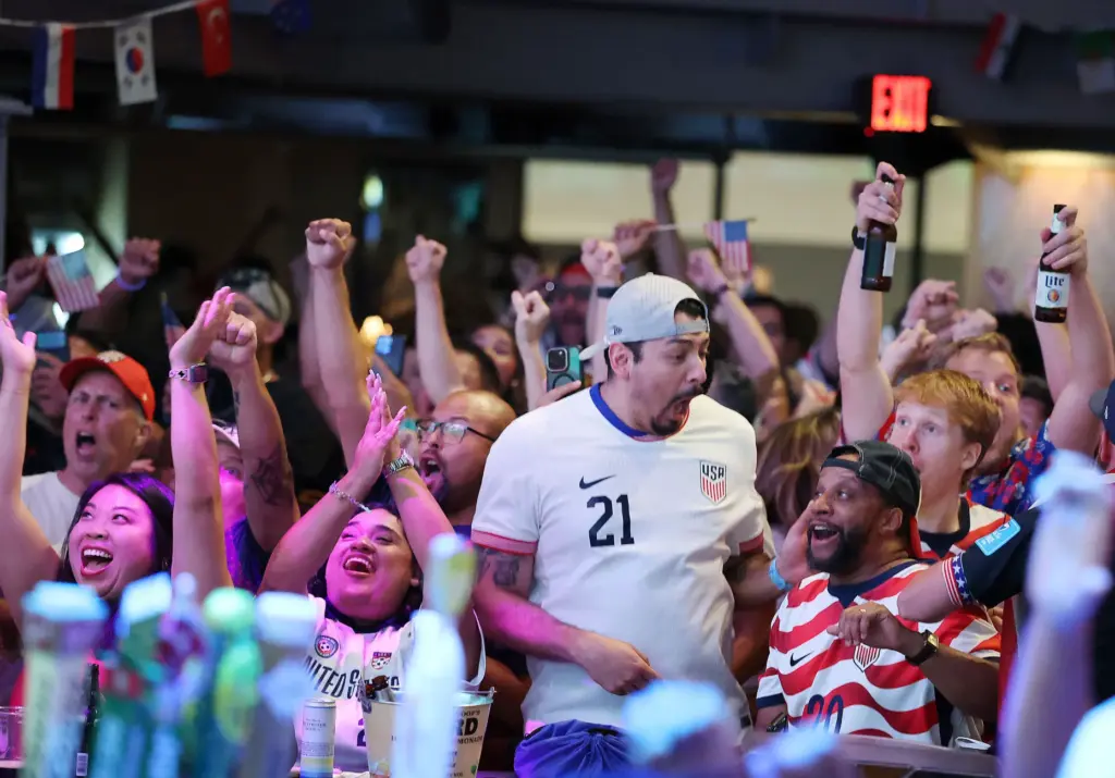 USA soccer fans cheer after a USA goal during a...