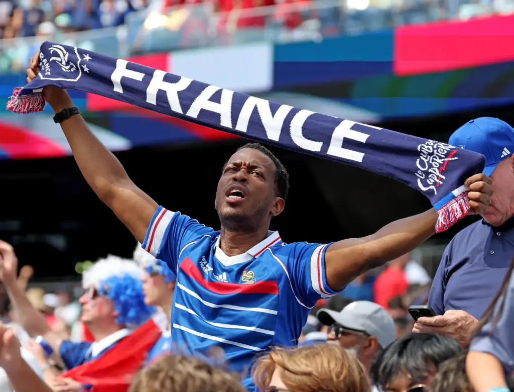 Foxboro, MA – July 9 – A French fan holds...