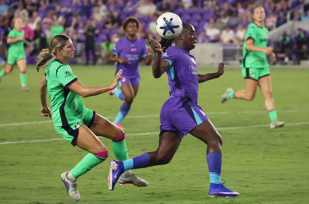 Orlando player Barbra Banda (middle) heads the ball during the...